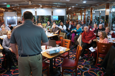 David Charash speaking at monthly meeting